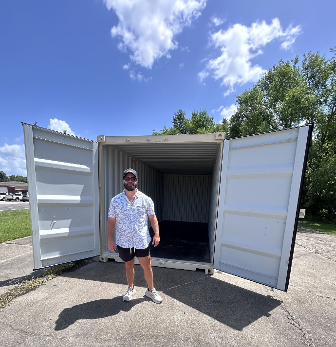 CJ, owner of Big Box Containers, standing in front of a 20’ 1-trip shipping container in Poplar Bluff, Missouri