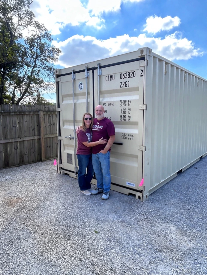 Happy customers posing with their new 20-foot BBC shipping container.